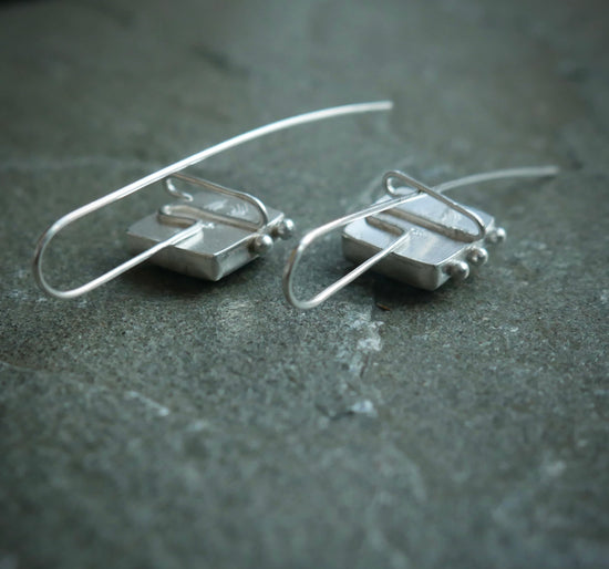 Frozen in Time: Swinging Snowflakes — A Pair of Bridewell Stone Drop Earrings in Sterling Silver